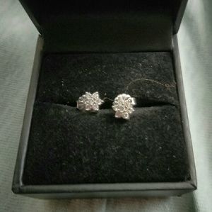 A pair of 14k diamond earrings star